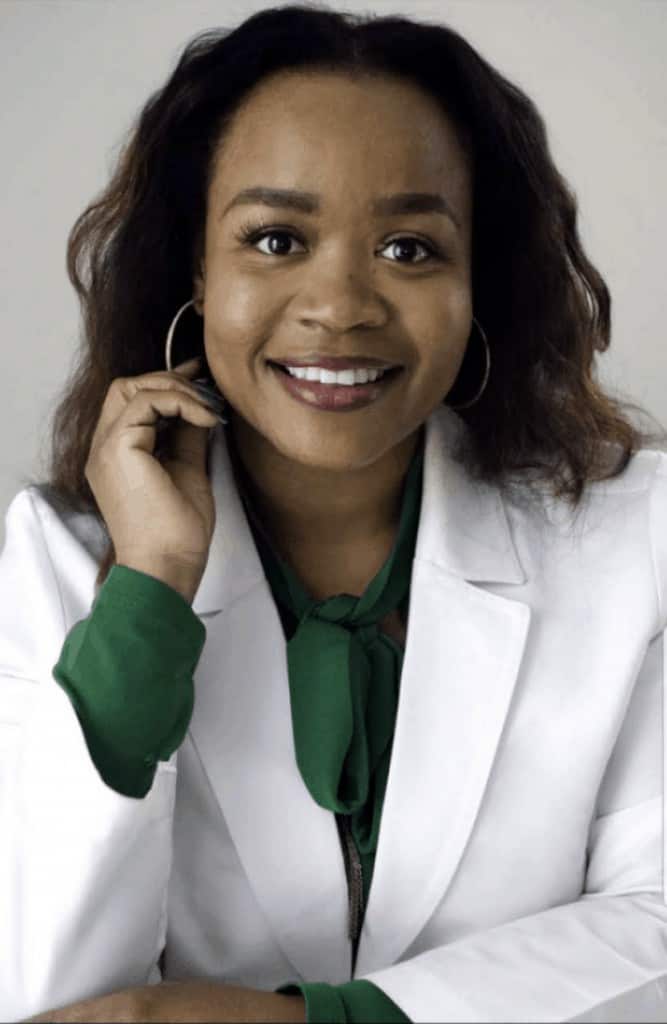 headshot of Kristen Jenkins looking ahead wearing white lab coat and green blouse